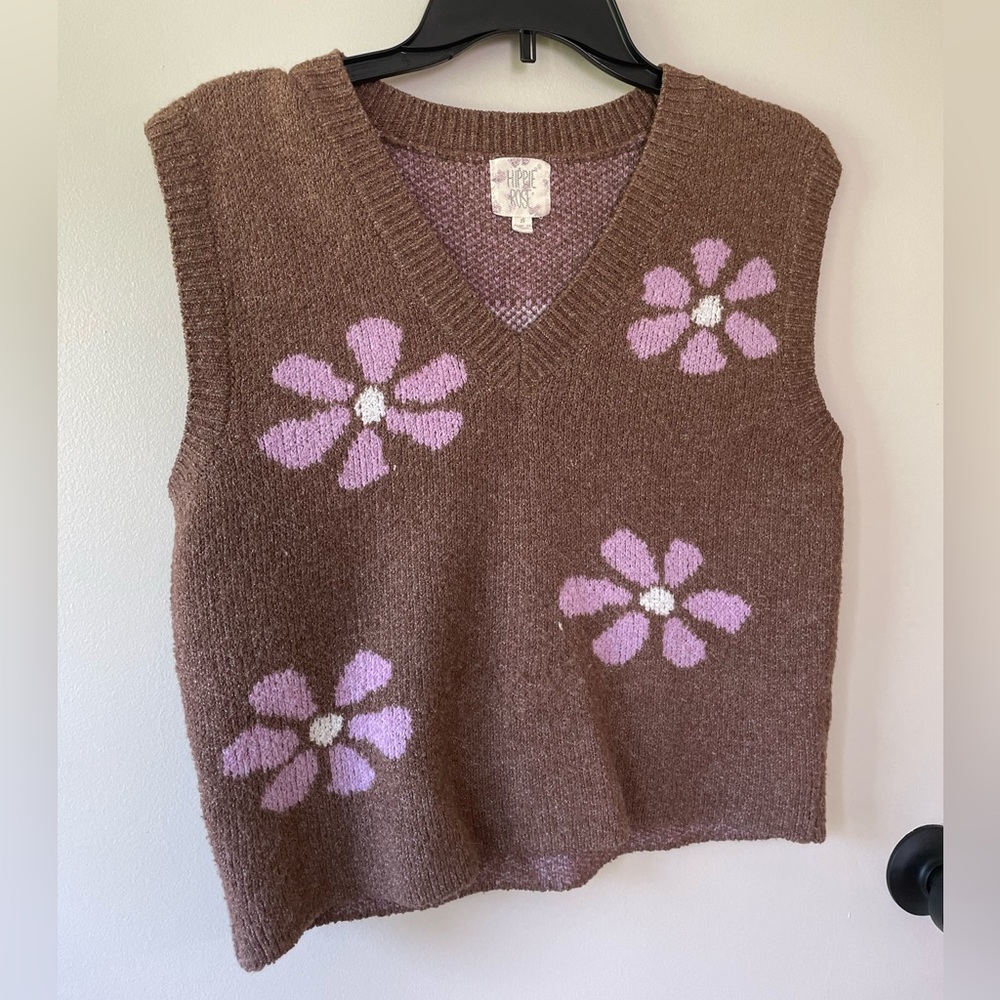 Brown sweater vest with purple flowers.